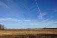 Contrail over field